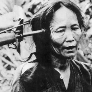 Vietnamese woman with a gun to her head, Vietnam War, 1969 (Keystone / Hulton Images / Getty)