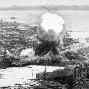 Para-demolition bombs being dropped on supply warehouses and dock facilities at a port in Wonsan, North Korea by the Fifth Air Force's B-26 Invader light bombers (ca. 1951)