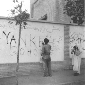 Tehran resident washes graffiti off wall, Aug. 21, 1953. The new Premier requested the clean-up after US coup