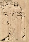 Blind Lady Justice carved into a Bronx court building