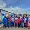 Luisa Cáceres communards assembled beside communal mural
