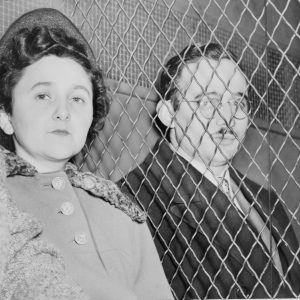 Julius and Ethel Rosenberg, separated by heavy wire screen as they leave U.S. Court House after being found guilty by jury